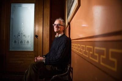 Andrew Greg with wood panelling and glass door